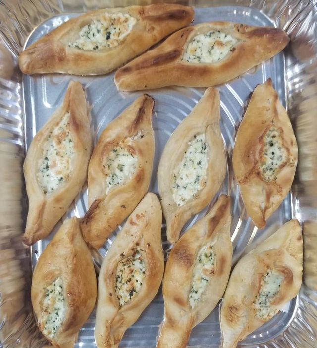 Tray of golden cheese boats filled with herbed cheese