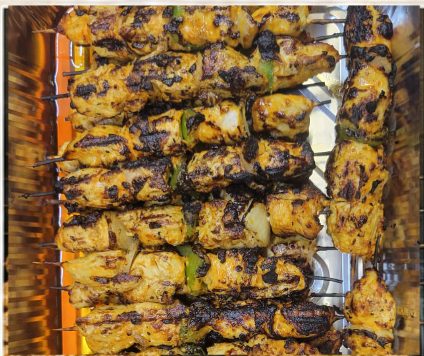 Grilled chicken kabob skewers on the charcoal grill