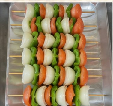 Vegetarian skewers of onion, tomato and green pepper